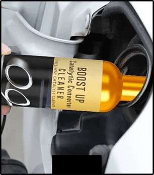 Cleaner bottle being poured into a vehicle fuel filler