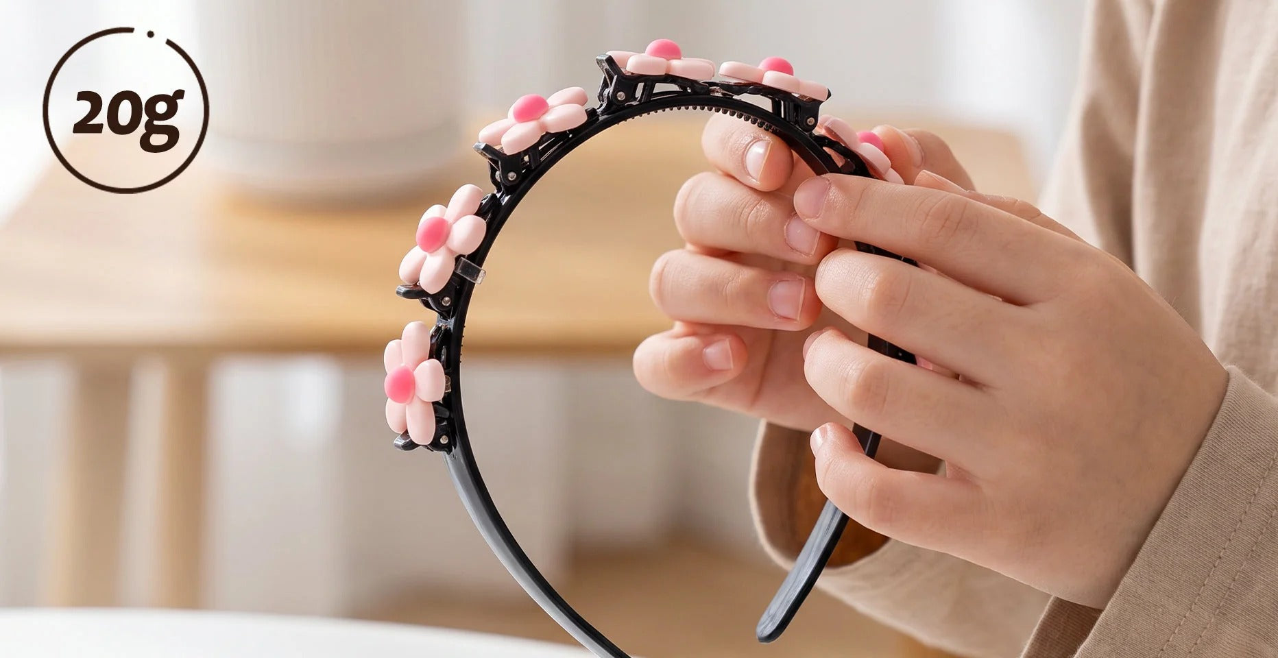 Flower headband held in hands, with a 20g label