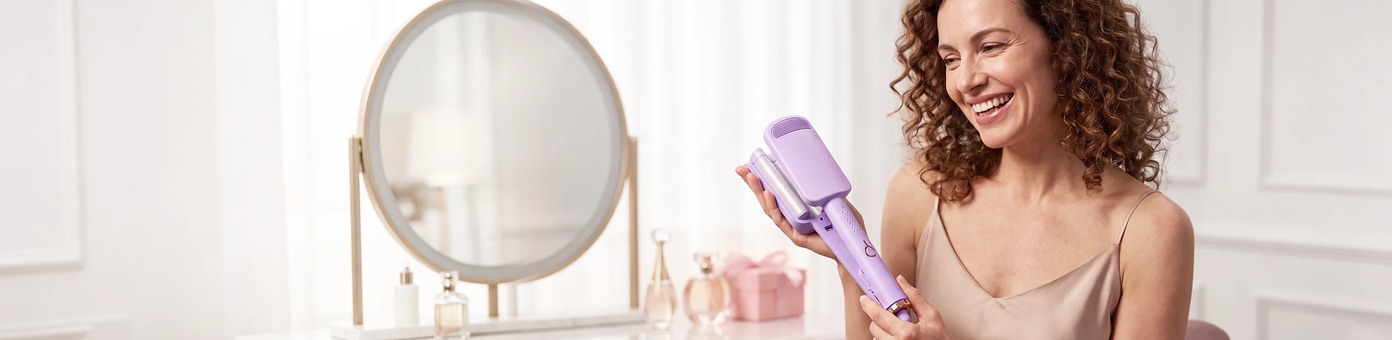 Woman smiling while holding a purple hair curler