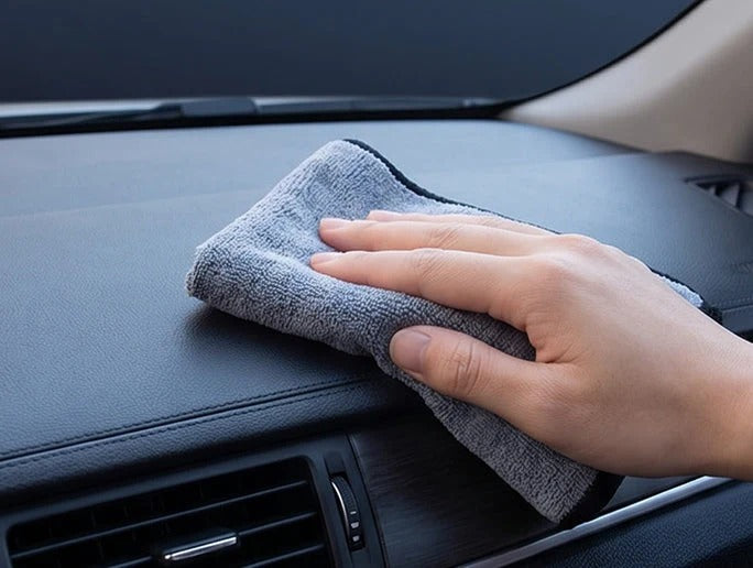 Wiping the dashboard with a cloth