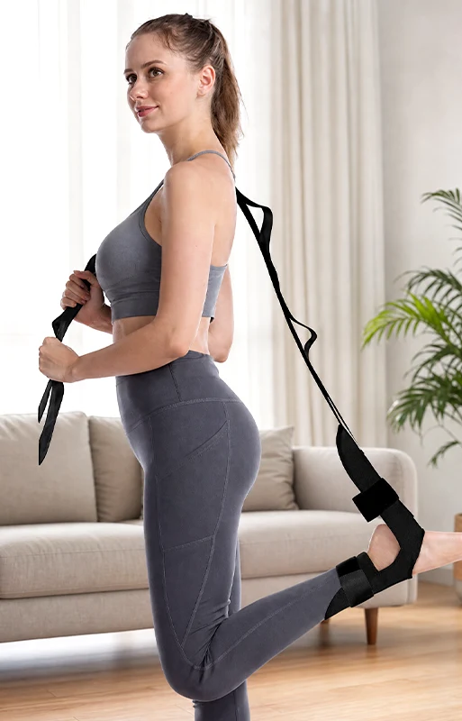 Woman using a stretching strap while standing