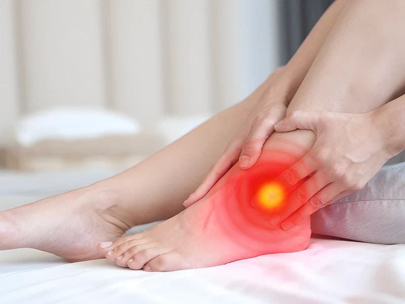 Person holding their foot with an illustrated discomfort highlight