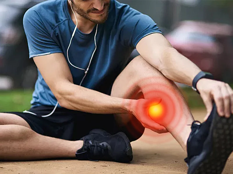 Athlete holding their lower leg after exercise